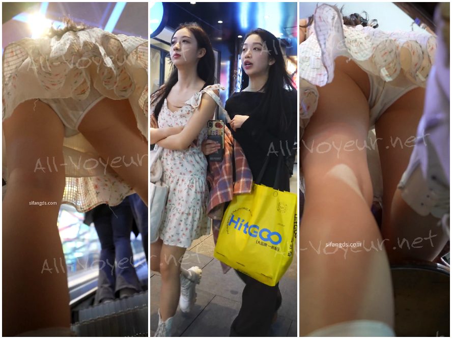 花柄のスカートをはいた美しい女性が、エスカレーターに足をかがめて下着を露わにしながら立っています。列に並んでいる間、ローアングルで撮影されています。