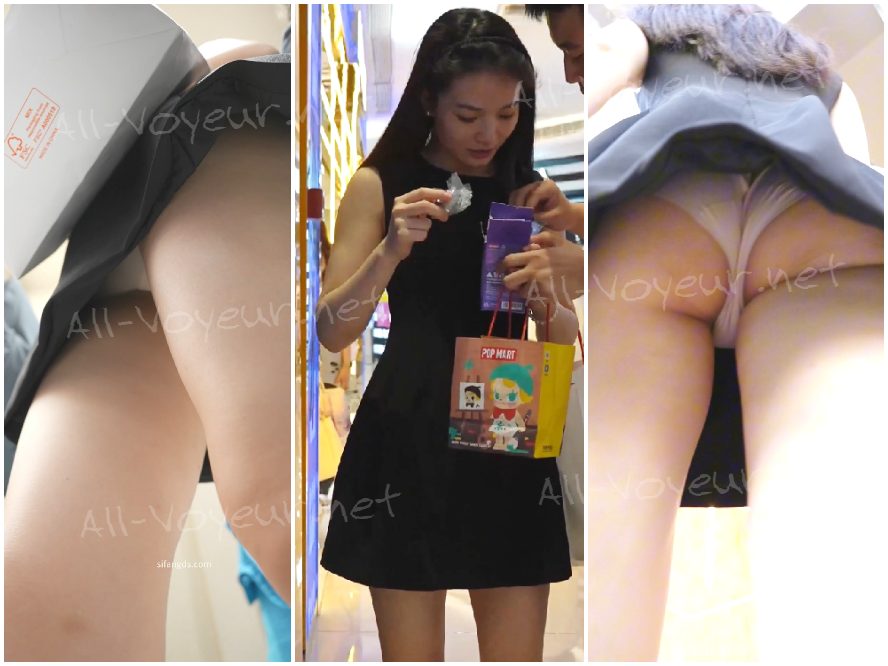 ピンクの長い髪と花柄のワンピースを着た女の子。彼女の柄物の紙の下着が洋服店で売り切れていました。