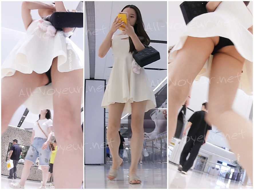 169 - 背中が開いた黒いミニドレス、フロントスリット、白いぴったりとした下着