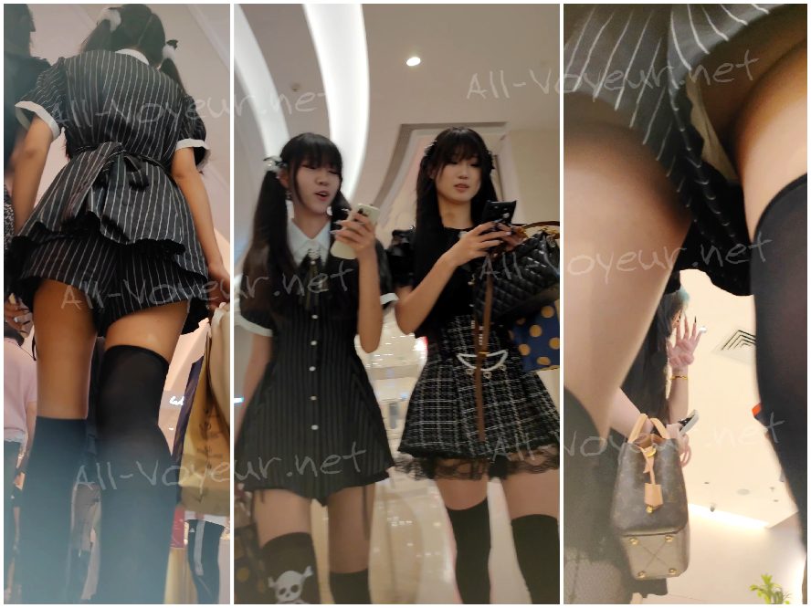 白い花柄のドレスを着た若い女性がボーイフレンドと一緒に買い物に来ています。彼女はフィットした黒のトップスを着ています。